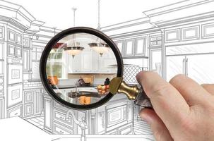 Hand Holding Magnifying Glass Revealing Custom Kitchen Design Drawing and Photo Combination