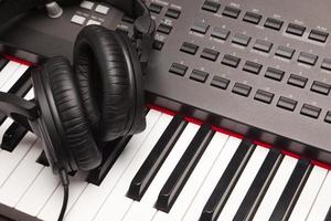 Listening Headphones Laying on Electronic Synthesizer Keyboard photo