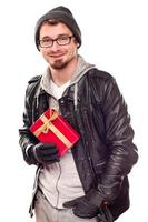 Warmly Dressed Handsome Young Adult Holding Gift photo