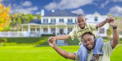 Playful African American Father and Son In Front of Home photo