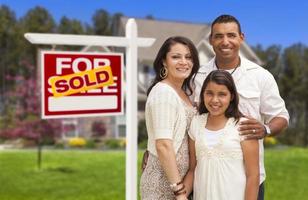 Hispanic Family in Front of Their New Home and Sign photo