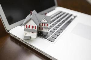 Miniature House on Laptop Computer photo