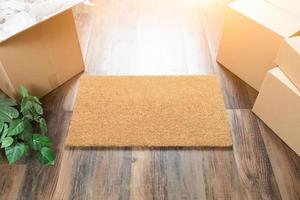 Blank Welcome Mat, Moving Boxes and Plant on Hard Wood Floors photo