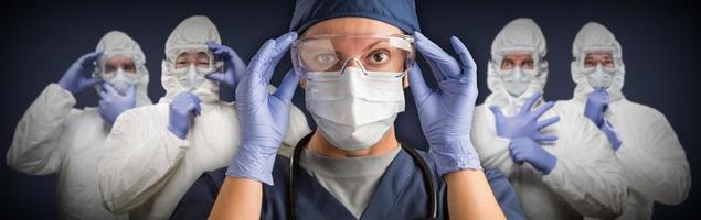 Team of Female and Male Doctors or Nurses Wearing Protective Medical Face Masks and Goggles Banner photo