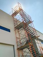 Industrial Construction Scaffolding and Ladder Along Building photo