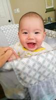 Adorable Chinese and Caucasian Baby Boy Playing In His Crib. photo