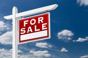 Right Facing For Sale Real Estate Sign Over Blue Sky and Clouds With Room For Your Text. photo