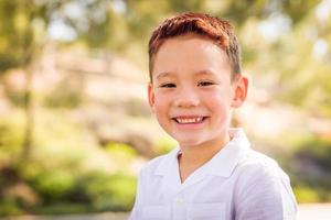 Outdoor portrait of a biracial Chinese and Caucasian boy. photo