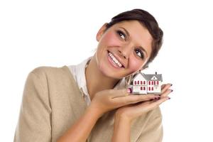 Ethnic Female Daydreaming with Small House on White photo