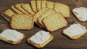 Biscuits craquelins salés secs isolés sur fond de bois video