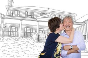 pareja de adultos mayores chinos besándose frente a los planos de dibujo de la casa personalizada.