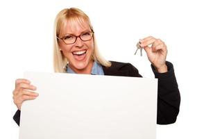 Attractive Blonde Holding Keys and Blank White Sign photo