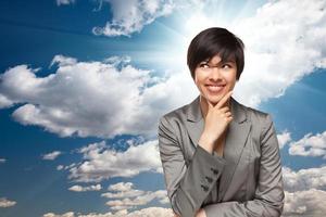 Pretty Multiethnic Young Adult Woman Over Clouds photo