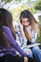 Stressed Sad Young Mixed Race Girl Being Comforted By Friend photo