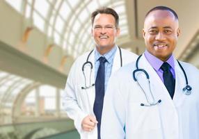 African American and Caucasian Male Doctors Inside Hospital photo