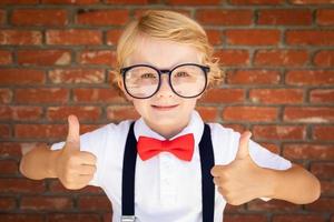 Cute Young Caucasian Boy With Thumbs Up Wearing Glasses and Red, White and Blue photo