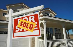 Sold Home For Sale Sign in Front of New House photo