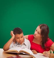 Blank Chalk Board Behind Hispanic Young Boy and Famale Adult Studying photo