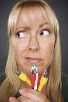 Confused Woman Holding Electronic Cables photo