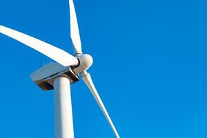 Single Wind Turbine Over Dramatic Blue Sky photo