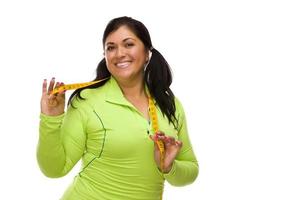 Hispanic Woman In Workout Clothes with Tape Measure photo