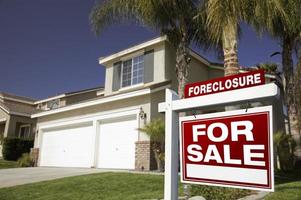 Red Foreclosure For Sale Real Estate Sign and House photo