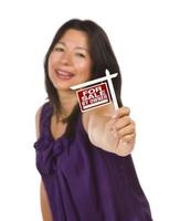 Multiethnic Woman Holding Small For Sale By Owner Real Estate Sign photo