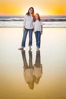 Two Young Sisters Portrait on The Beach. photo