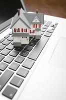 Miniature House on Laptop Computer photo