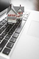 Miniature House on Laptop Computer photo