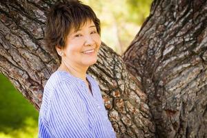 Outdoor portrait of a happy senior adult Chinese woman. photo