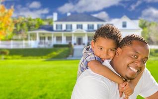 Mixed Race Father and Son In Front of House photo