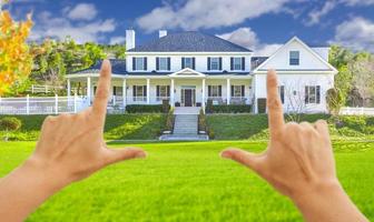 Female Hands Framing Beautiful House photo