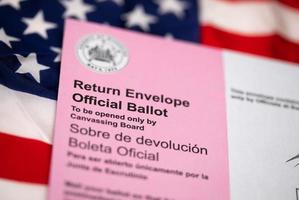 Vote-By-Mail Ballot Envelope Laying on American Flag photo