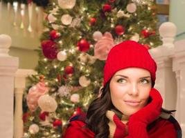 Warmly Dressed Female In Front of Decorated Christmas Tree. photo