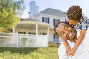 African American Father and Mixed Race Son, House Behind photo