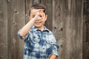 Young Mixed Race Boy Making Hand Gestures photo