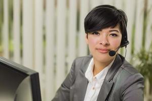 Attractive Young Mixed Race Woman Smiles Wearing Headset photo