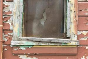 Weathered Wood Panel Wall and Window With Peeling Paint Textured Background photo