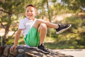 Outdoor portrait of a biracial Chinese and Caucasian boy. photo