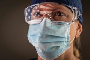 American Flag Reflecting on Female Medical Worker Wearing Protective Face Mask and Goggles photo