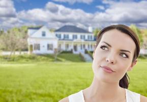 Thoughtful Mixed Race Woman In Front of House photo