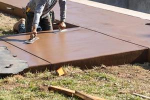 Construction Worker Smoothing Wet Cement With Trowel Tools photo