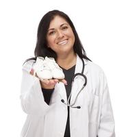 Hispanic Female Doctor or Nurse with Baby Shoes on White photo