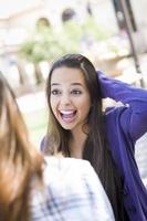 Expressive Young Mixed Race Female Sitting and Talking with Girlfriend photo