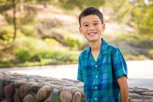 Outdoor portrait of a biracial Chinese and Caucasian boy. photo