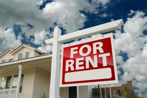 For Rent Real Estate Sign in Front of House photo