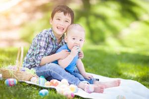 Mixed Race Chinese and Caucasian Boys Outside in Park Playing with Easter Eggs photo
