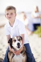 Handsome Young Boy Playing with His Dog photo