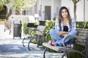 Mixed Race Female Student Portrait on School Campus Bench photo